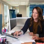 woman working in office after taking online office diploma