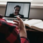 the benefits and challenges of online learning banner man talking in video call